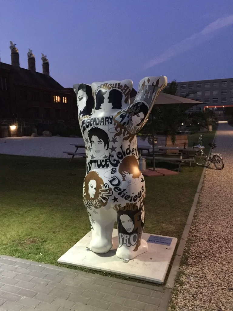 Charming Bear — Buddy Bear seen from the back at dusk